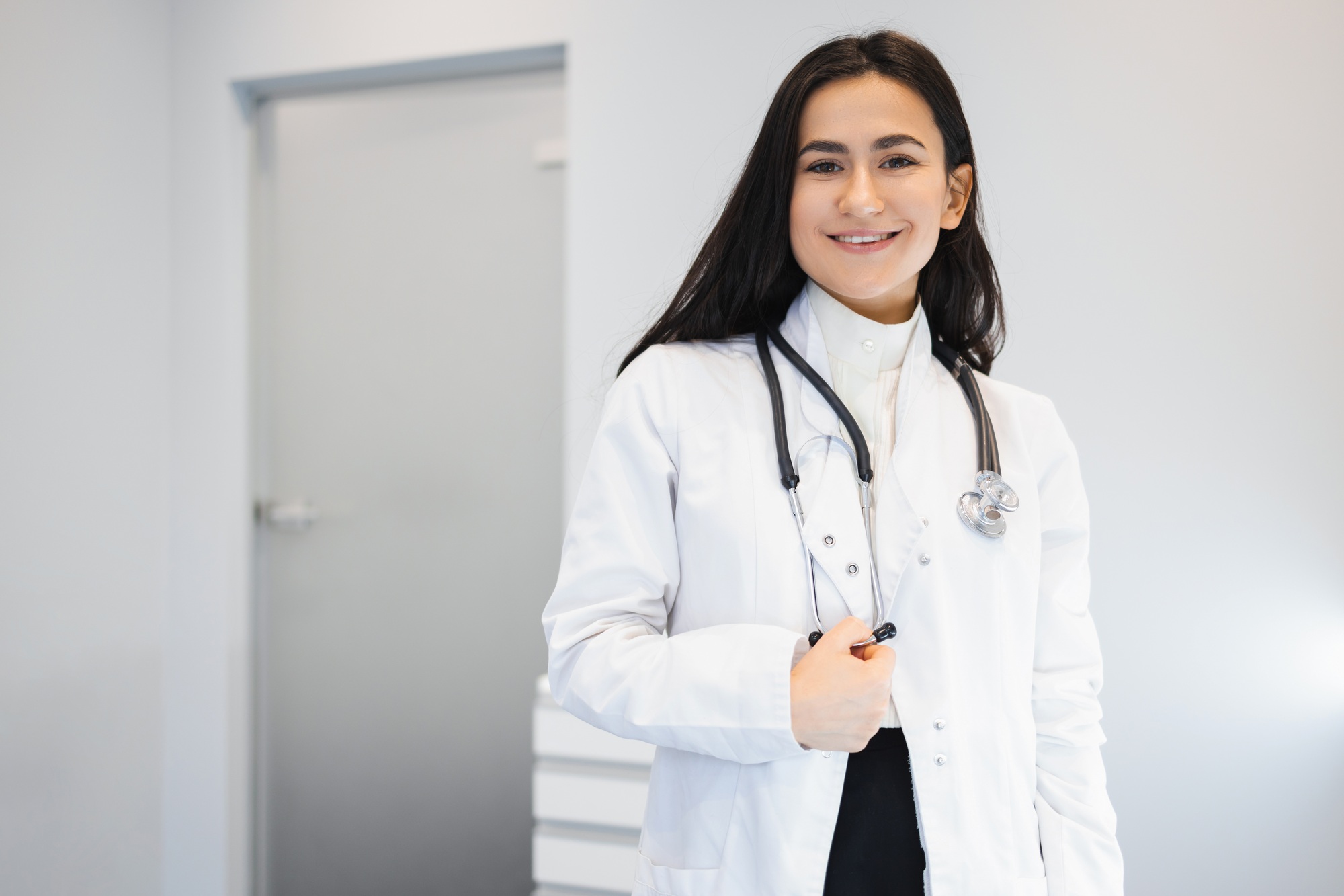 Portrait of happy female doctor with stethoscope in office